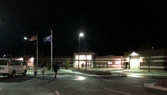 POW-MIA, New York State and the American Flags stand in front of St. Lawrence County Correctional Facility on a dark night